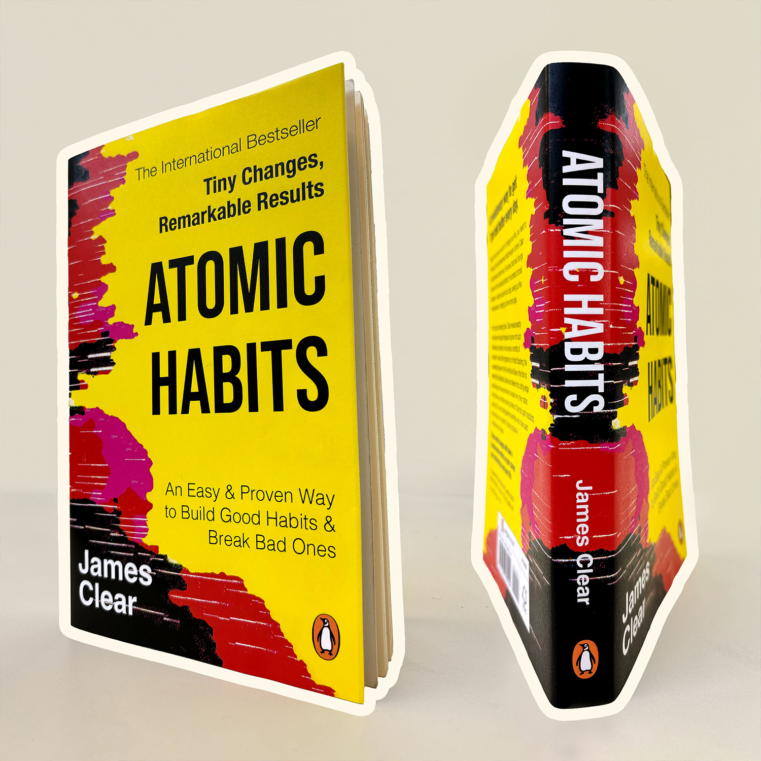 Mockup of Atomic Habits book with red and balck spine merging into yellow front ant back